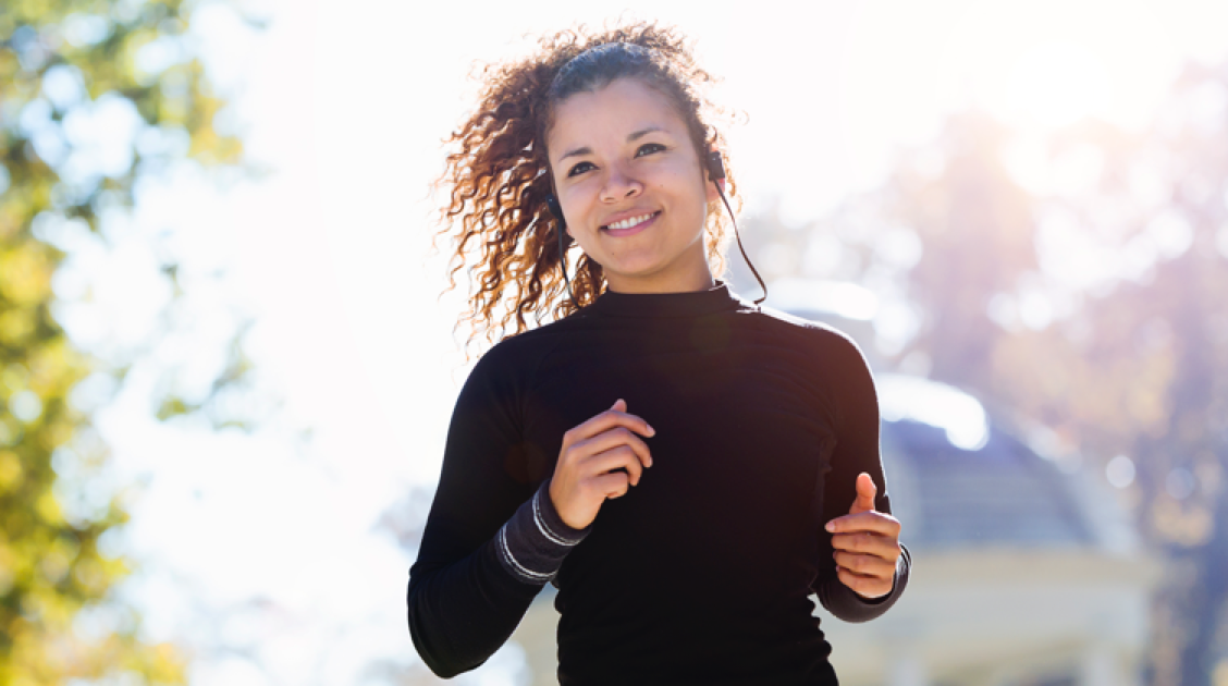 woman jogging outside with music listener